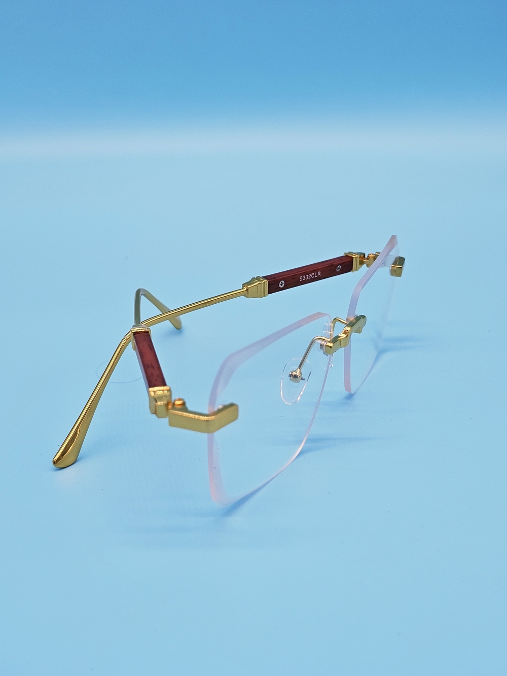 Gold Rimless Men's Eyewear with Pink Tint Temples
